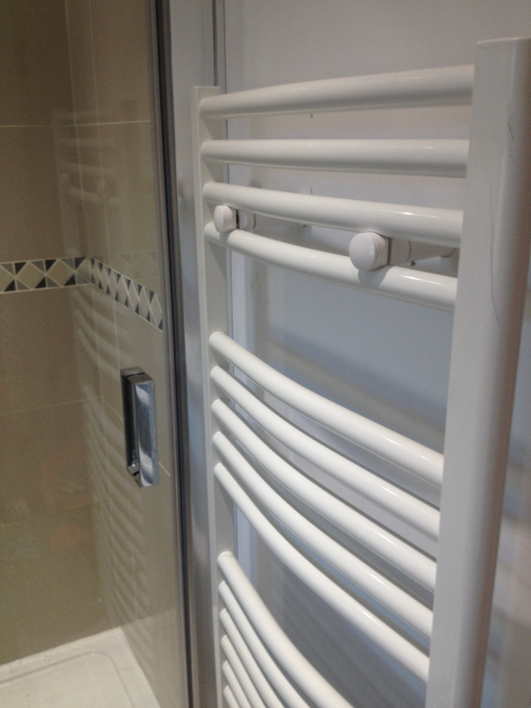 white towel radiator by shower