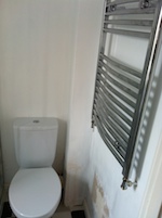 chrome bathroom towel radiator by toilet