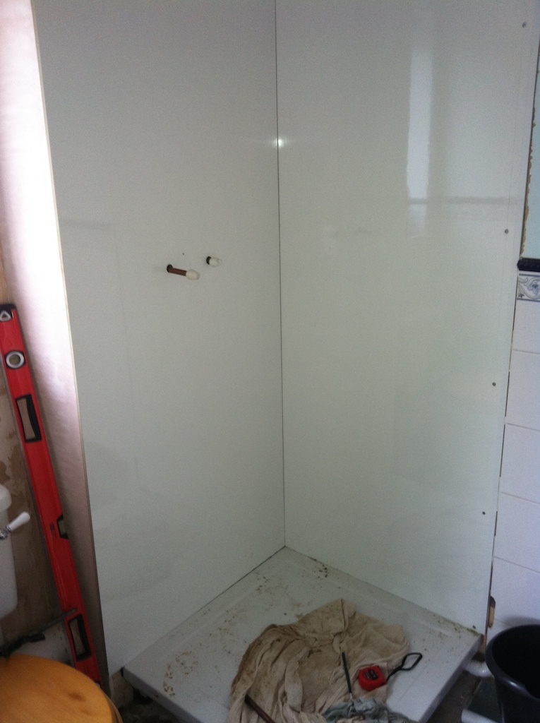partially completed shower cubicle with white walls