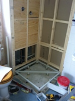 the wood framing of a partially constructed square shower cubicle