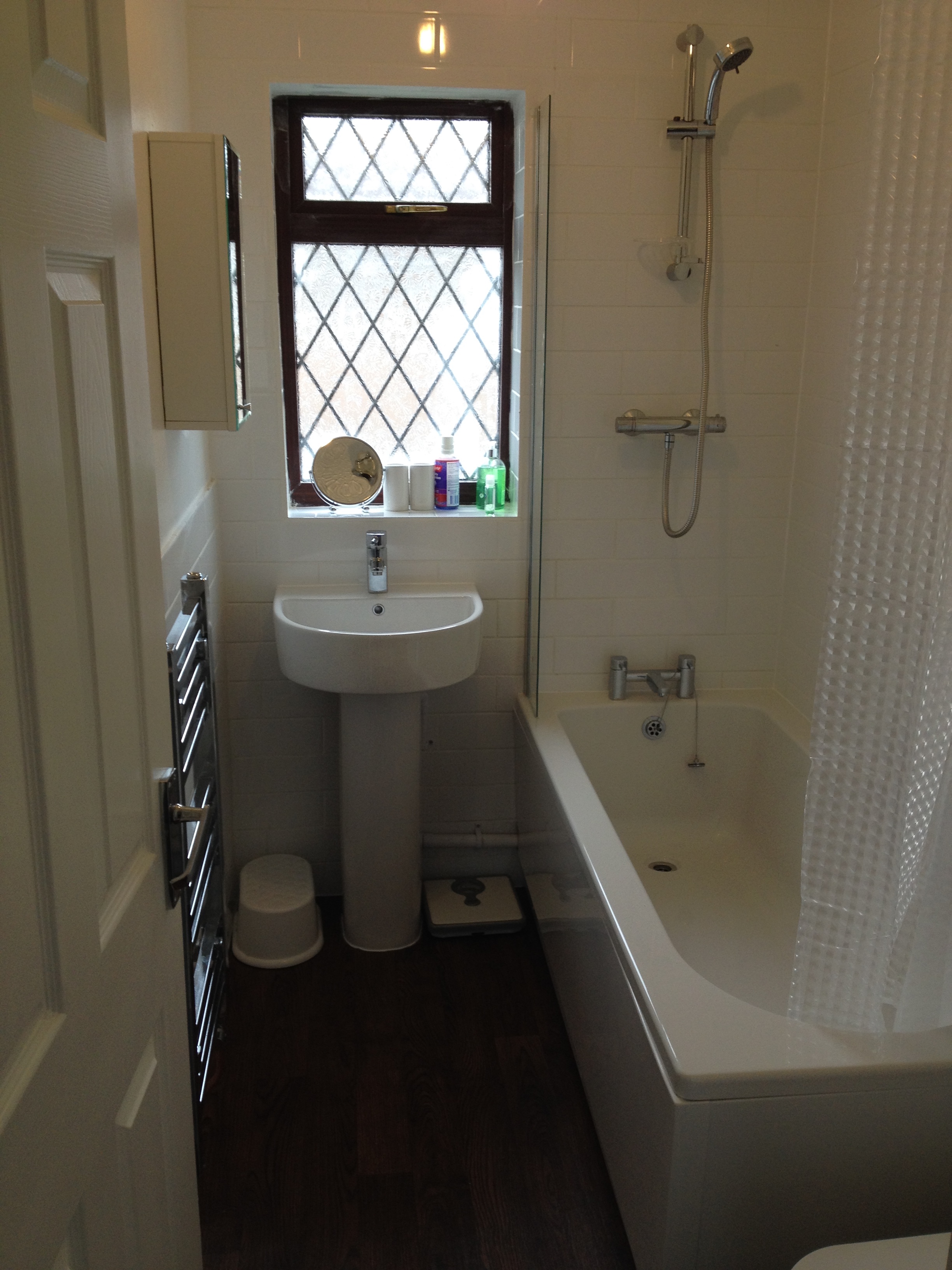 chrome towel radiator, half circle sink and bathtub installation in Cambridgeshire
